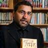 James Ahmed, London author, holding a signed novel
